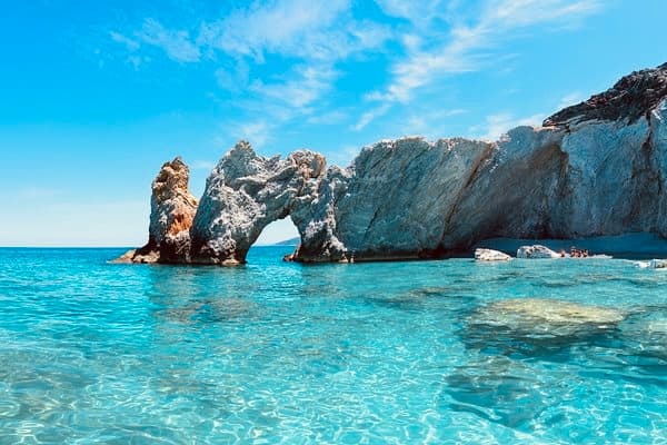 Crystal clear waters and rock arch in Skiathos